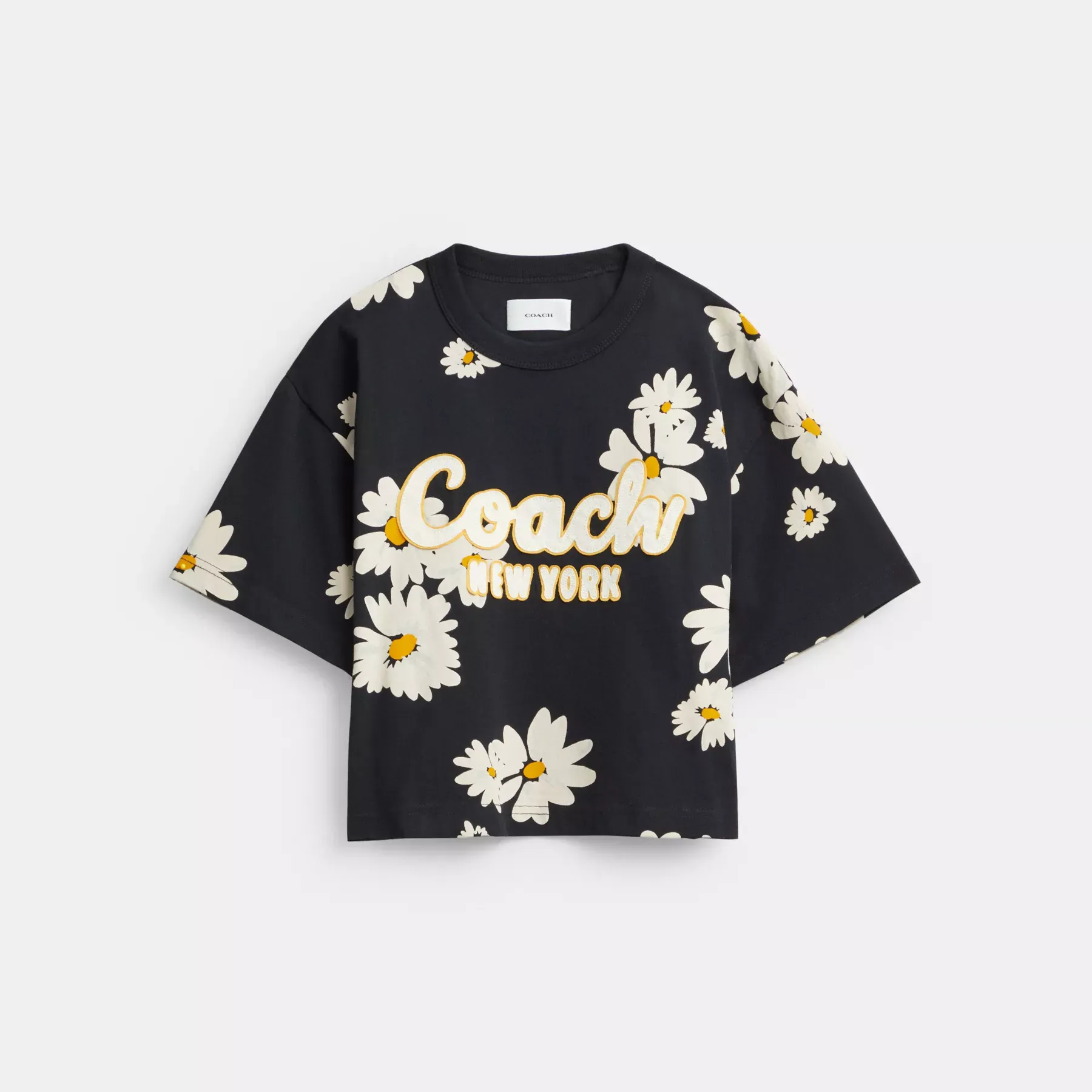 COACH Kurzes T-Shirt aus Bio-Baumwolle mit floralem Signature-Schriftzug Schwarz Multi